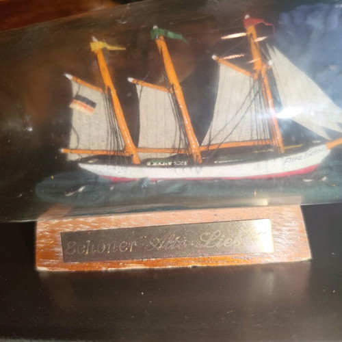 Ship in a bottle used with sealed top and wooden base