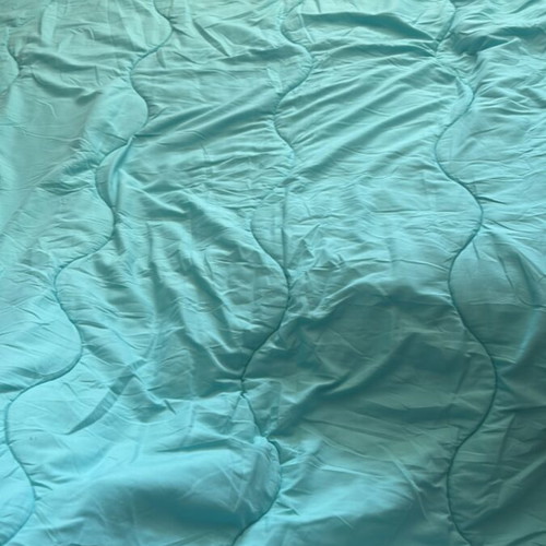 Light blue quilt used for one-and-a-half mattress