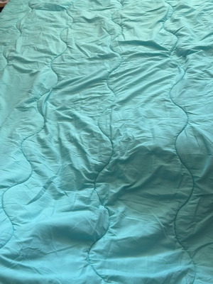 Light blue quilt used for one-and-a-half mattress