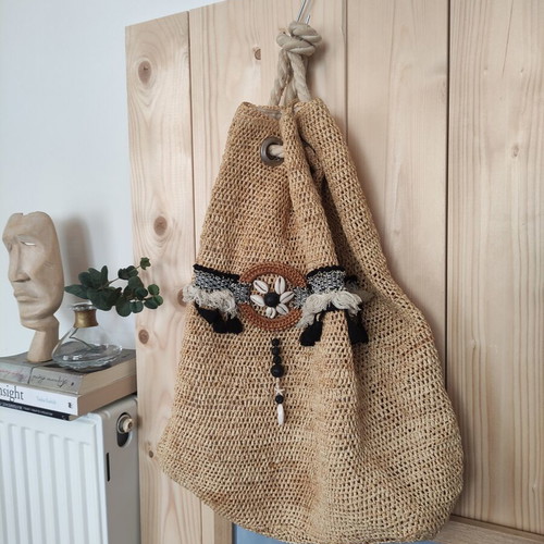 Boho straw backpack used with shells and rope straps, resort style