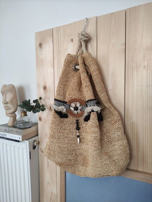 Boho straw backpack used with shells and rope straps, resort style