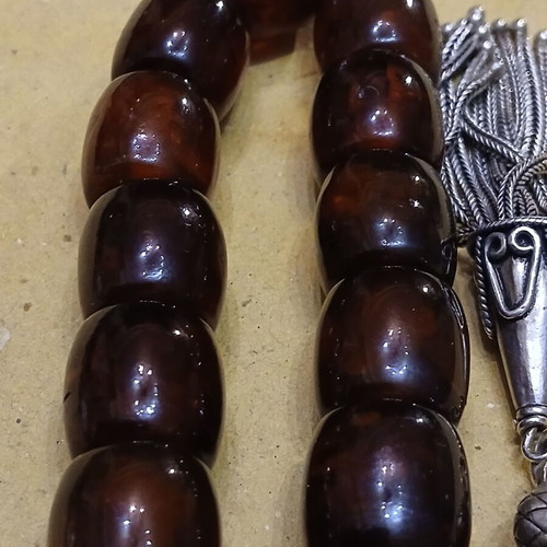 Amber worry beads used with silver elements and tassel