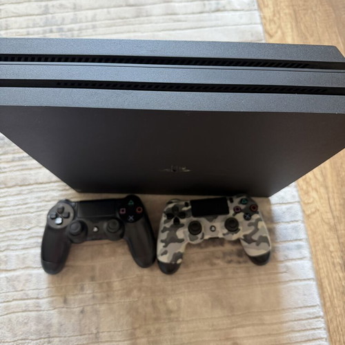 PlayStation 4 Pro 1TB console used with 2 original controllers and games