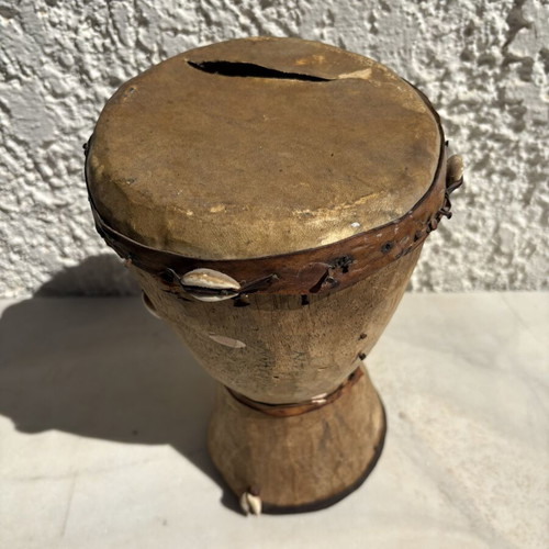 Handmade wooden drum used, African style with leather membrane and shells