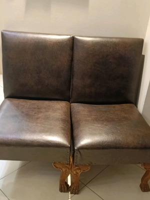 Set of two low chairs used with leatherette and wooden frame