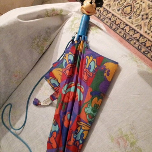 Disney umbrella used with blue Mickey Mouse handle, multicolored