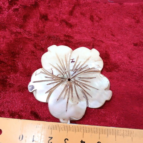 Carved coffee-yellow mother-of-pearl element with hole hibiscus shape