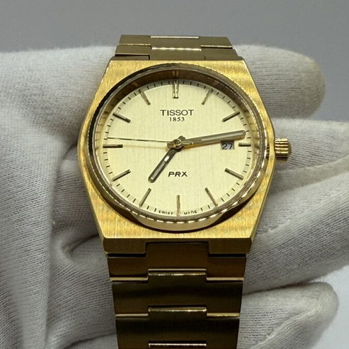 Tissot PRX Quartz watch with golden dial