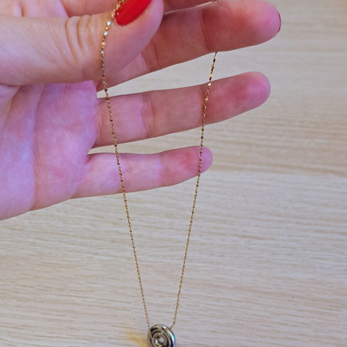 Necklace with gold tone chain and silver round pendant like new