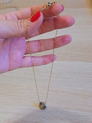 Necklace with gold tone chain and silver round pendant like new