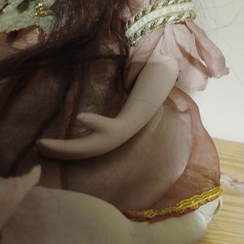 Porcelain doll sitting pose