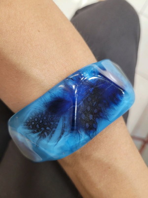 Bracelet with embedded feathers like new