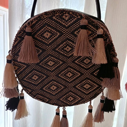 Round crossbody bag black like new, with tassels