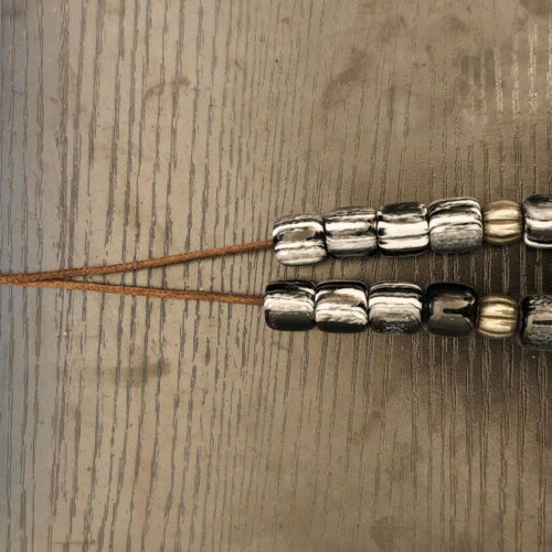 Worry beads used with black and white beads, metallic elements