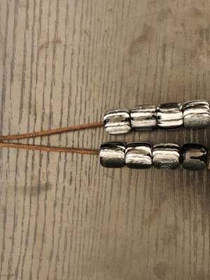 Worry beads used with black and white beads, metallic elements