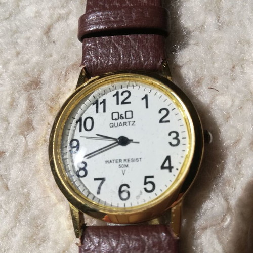 Q&Q wristwatches used with brown leather straps, blue one has glass damage