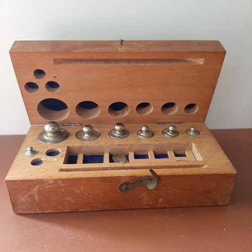 Wooden collectible box with cast iron weights
