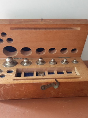Wooden collectible box with cast iron weights