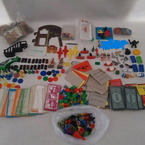 Lot of used game pieces, cards, and play money