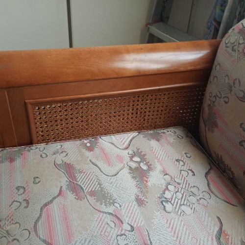 Two-seater sofa bed with wooden frame and rattan sides