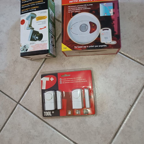 Security package used with ceiling motion alarm, door & window entry alarm, and realistic security camera