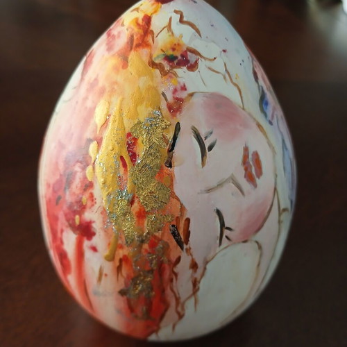 Hand-painted ceramic egg with floral and female figure design