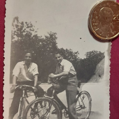 Vintage black and white photo of two men with bicycles used