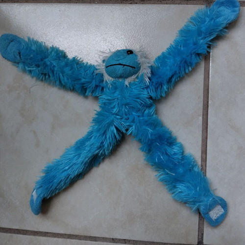 Stuffed chimpanzee hanging like new