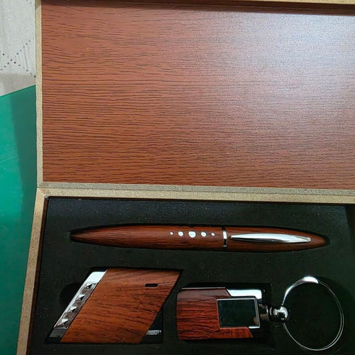 Set of three gifts in luxury wooden box with pen, lighter and keychain