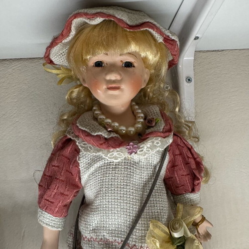 Porcelain doll new with tag and base