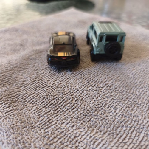 Land Rover Defender and Cord Camaro toy cars, set of 2