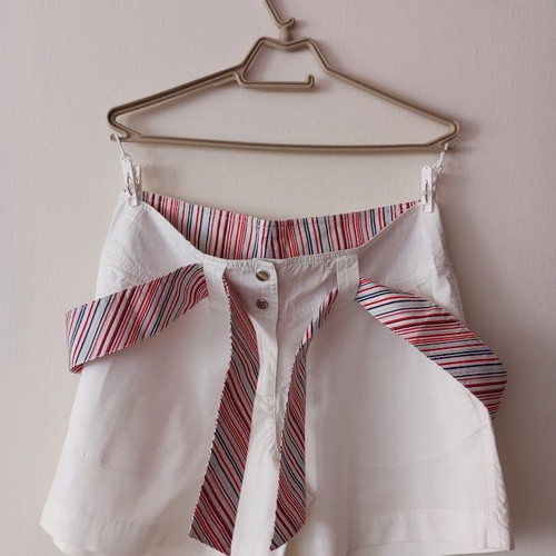 Red sleeveless blouse like new with white shorts and striped belt