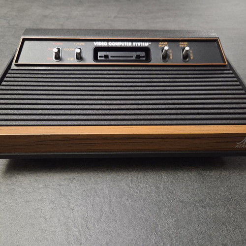 Atari 2600 VCS Woody console used with two joysticks and Demon Attack game