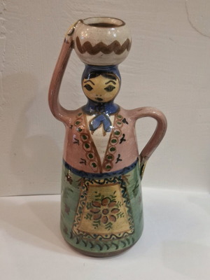Handmade clay candle holder used with female figure and traditional costume