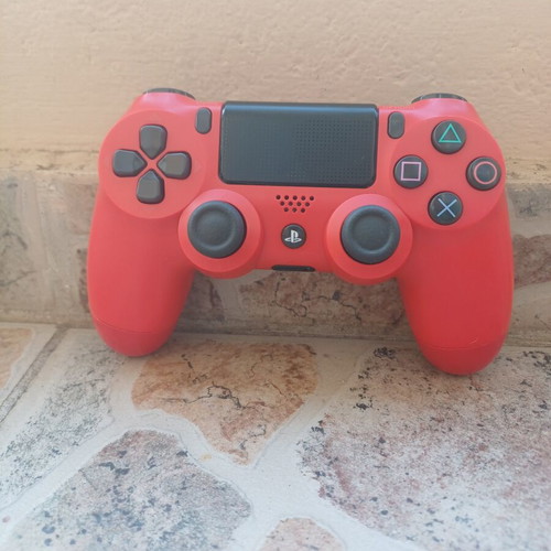 PlayStation 4 Slim 1TB console with red DualShock 4 and charging dock