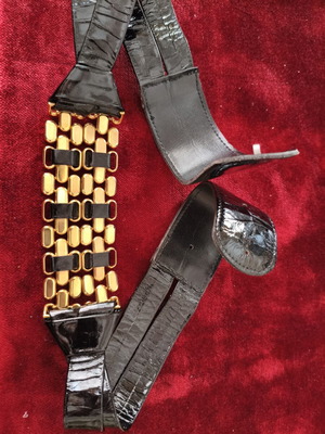 Black patent leather belt used with gold metal design