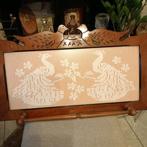 Handmade carved frame with crocheted peacocks design