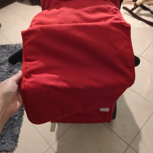 Kiddo Smart Deluxe stroller used with footmuff and changing bag, red