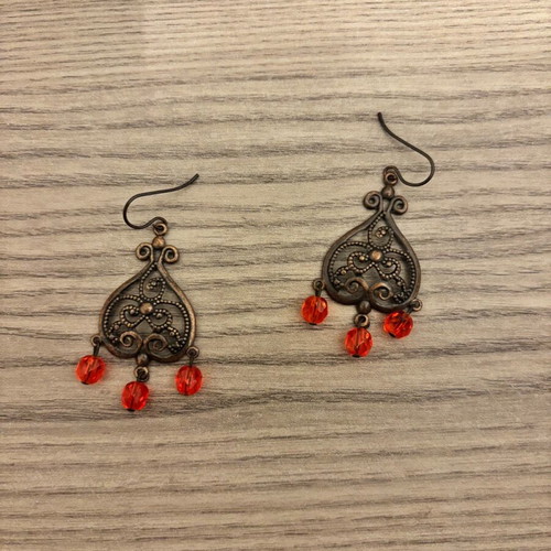 Earrings used with red plastic beads and bronze metal