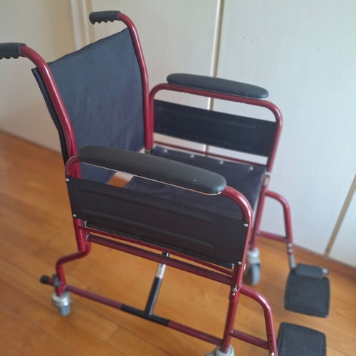 Transport wheelchair with metal frame and brakes