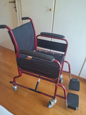Transport wheelchair with metal frame and brakes