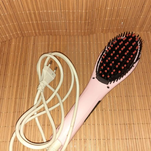 Electric hair straightening brush used