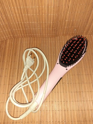 Electric hair straightening brush used