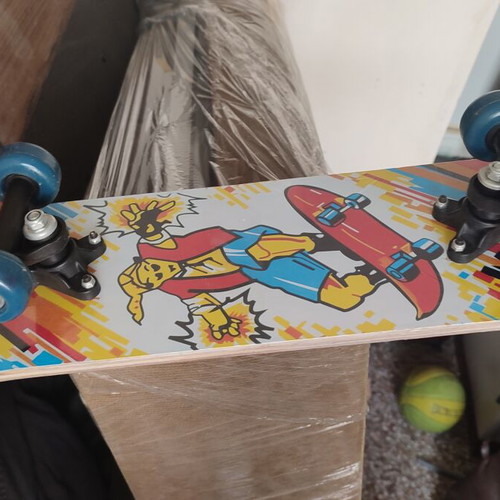 Children's skateboard with colorful comic design, sealed