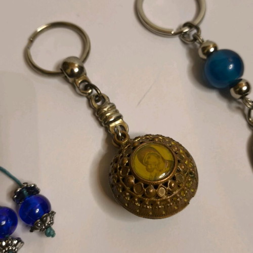 Set of 3 keychains like new with Meteora, evil eye and religious images