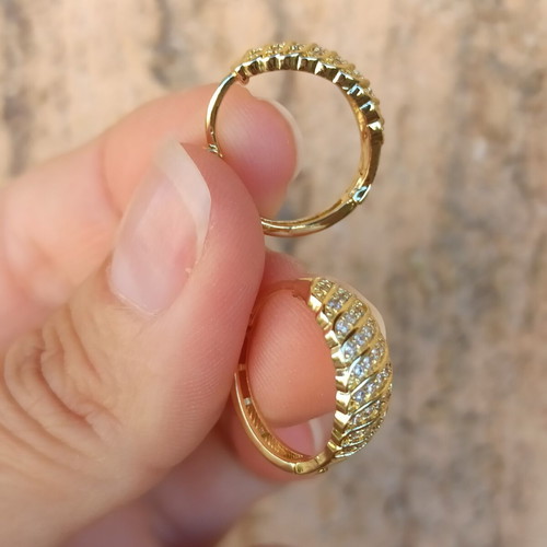 Gold-colored hoop earrings with white zircon stones, copper
