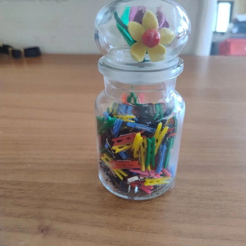 Storage jar with small clothespins for crafts