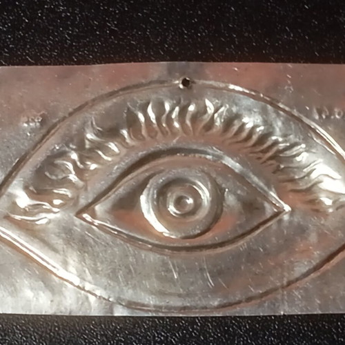 Silver votive with eye depiction used