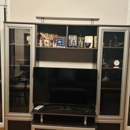 Living room unit like new with glass cabinets and TV space