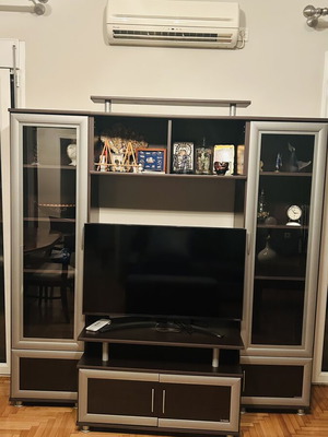 Living room unit like new with glass cabinets and TV space